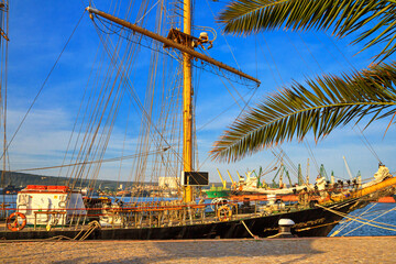 View of the port of Varna and the embankment with sailing ship, harbor cranes in the background, on...