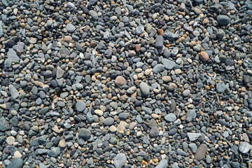 Close up of pebbles on a beach forming an abstract pattern