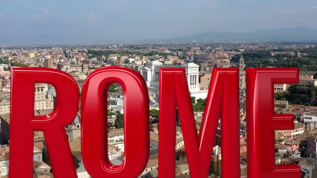 Roma scritto a caratteri cubitali sullo sfondo dell'Altare della Patria e del Colosseo.
Vista aerea della scriita "ROMA" in 3D sui fori Imperiali, sul Colosseo e sull'Altare della Patria.