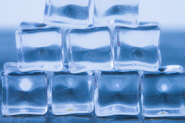 Melting ice cubes on a cool blue background