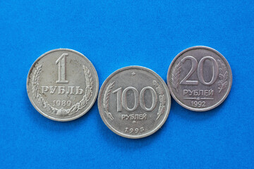 Soviet Russian coins 1 20 100 rubles isolated on a blue background close-up top view