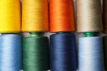 Colorful thread spool background, close-up