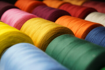 Colorful thread spool background, close-up - obrazy, fototapety, plakaty
