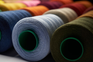 Colorful thread spool background, close-up