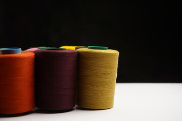 Colorful thread spool background, close-up
