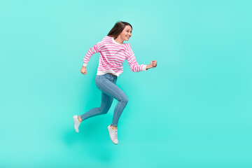 Fototapeta na wymiar Full length body size view of attractive cheerful trendy focused girl jumping running isolated over shine teal turquoise color background
