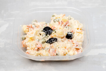 typical vegetable salad with sauce in plastic box