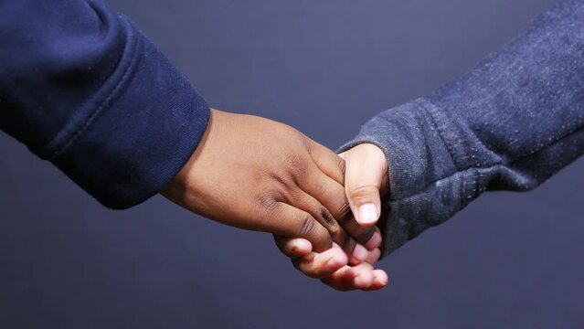 f child girl holding hand of her bother 