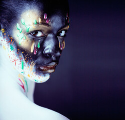 woman with creative makeup closeup like drops of colors, facepaint close up halloween