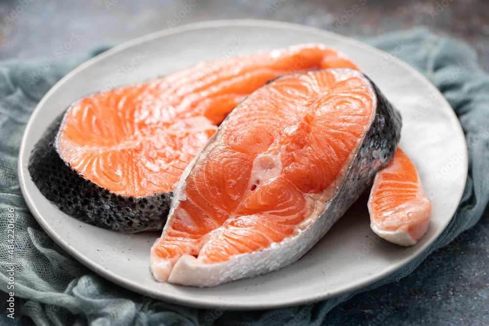 Sticker raw fresh salmon on ceramic plate with napkin on ceramic