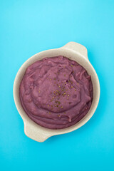 mashed sweet potato in the bowl on blue