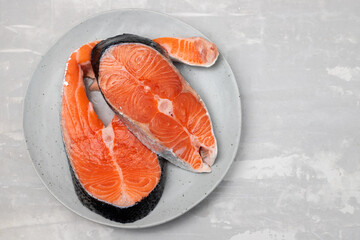 raw fresh salmon on ceramic plate with napkin on ceramic