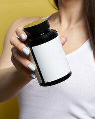 woman hand hold drag or medicine bottle on white background - 484221404