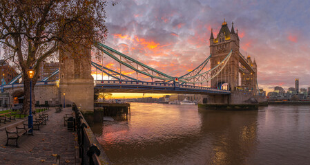 Panoramic view of Tower Bridge and River Thames with dramatic sky at sunrise, London, England