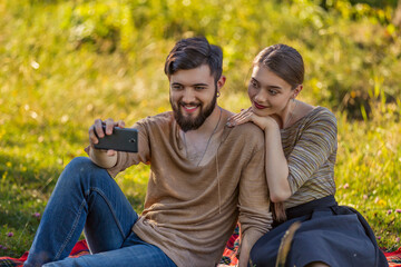 young couple taking a selfie in nature