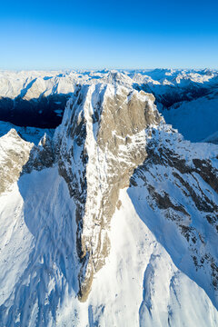 Clear winter sky over majestic Pizzo Badile covered with snow, Val Masino, Valtellina, Sondrio province, Lombardy, Italy