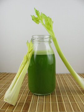 Fresh pressed celery juice in a small glass bottle