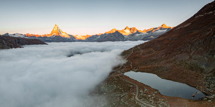 Matterhorn, Dent Blanche, Wellenkuppe and Zinalrothorn peaks in fog from Stellisee lake, Zermatt, Valais canton, Swiss Alps, Switzerland