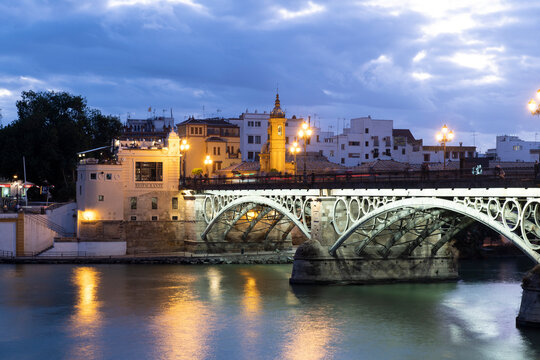 The Triana Bridge (Puente de Triana) (Puente de Isabelle II) at twilight, Seville, Andalucia Spain