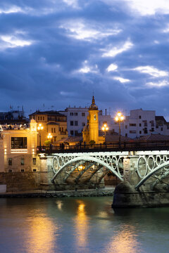 The Triana Bridge (Puente de Triana) (Puente de Isabelle II) at twilight, Seville, Andalucia Spain