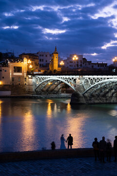 The Triana Bridge (Puente de Triana) (Puente de Isabelle II) in Seville at twilight, Seville, Andalucia