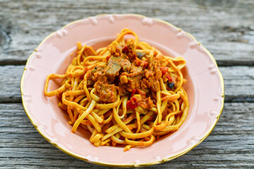 Traditional indonesian meal bami goreng with noodles, vegetables and chicken