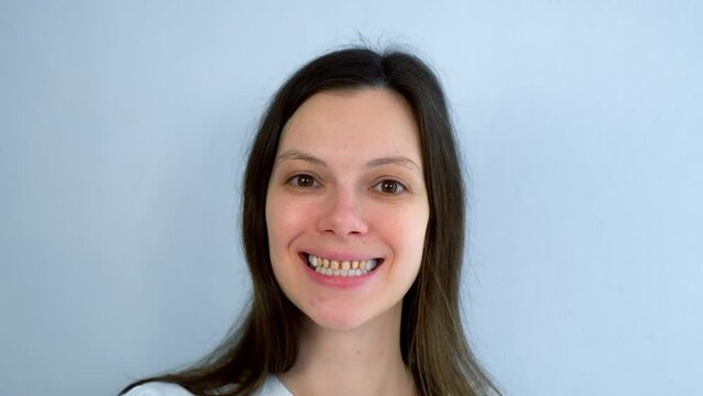 Portrait of woman with yellow bad teeth is smiling and looking at camera. Teeth sharpened by a dentist before installing crowns and ceramic veneers. Dentistry treatment, prosthetics of teeth concept.