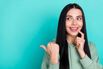 Photo of sweet young black hairstyle lady look empty space wear green sportscloth isolated on...