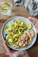 Delicious plate of zucchini spaghetti with lemon and butter prawns. Delicious and healthy home cooking