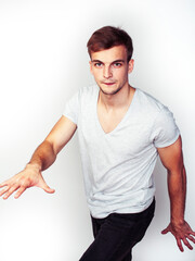 Obraz premium young handsome teenage hipster guy posing emotional, happy smiling against white background isolated, lifestyle people concept
