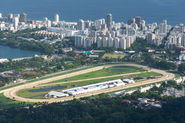 Beautiful view to city buildings and lagoon from green mountain