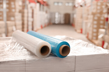 Rolls of different stretch wraps on boxes in warehouse
