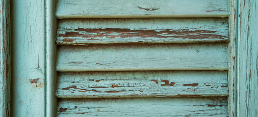 Vintage wood background. Old weathered wooden plank painted in green color. Boards with cracked and peeling paint. Old painted wood wall - texture or background.