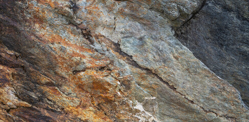 Brown rocks background or texture. Detail of natural stone. Natural concentric patterns and textures of minerals for background. Natural stone surfaces, background.