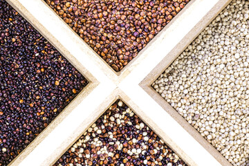 Red, black and white and mixed quinoa seeds on white background. Vegetarian food
