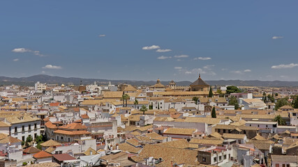 Fototapeta na wymiar High angle view on the tradititonal houses of Cordoba, Andalusia, Spain, with mountains in the background 