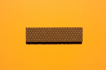 Chocolate wafers on orange background	