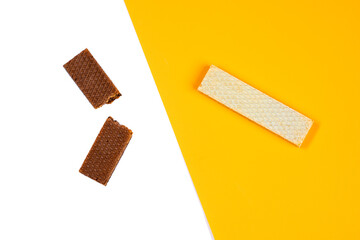 Chocolate wafers on white yellow background	