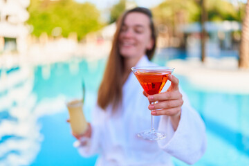 Young happy smiling joyful woman enjoy of summer vacations with refreshing pina colada and aperol...