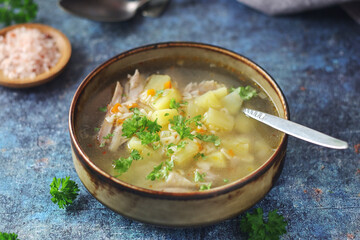 A bowl with chicken soup with pasta