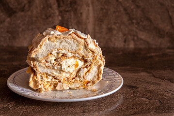 Delicate and airy meringue cake on a plate on the table.