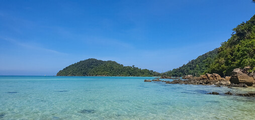 Emerald sea water and beautiful natural rocky seashore. Summer vacation and coastal nature concept.Beautiful small bay with crystal clear turquoise sea water