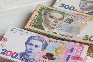 Stack of ukrainian hryvnia banknotes on table