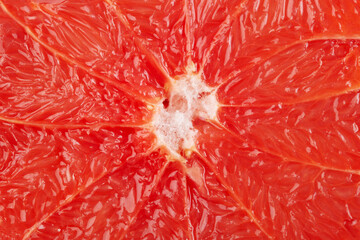 Sliced pink grapefruit closeup macro shot as a background