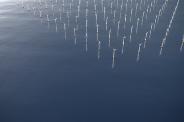 3D rendering: Photorealistic image of a windmill park in the sea. Copyspace available.
