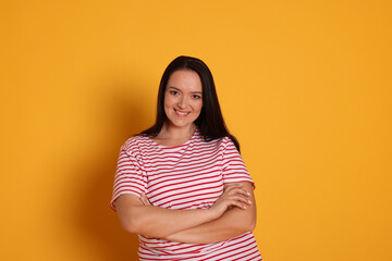 Obraz premium Beautiful overweight woman with charming smile on yellow background