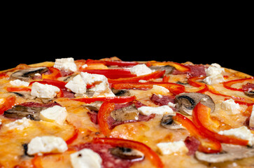 Close-up pizza, cheese, mushrooms, feta, bell pepper. Traditional Italian cuisine.