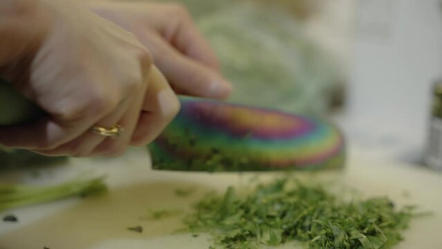 person cutting parsley