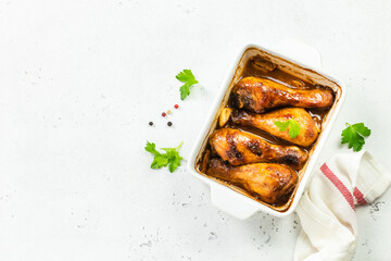 Slow cooker asian glazed chicken drumsticks in baking dish. Top view, copy space.