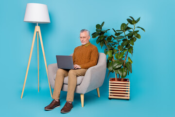 Full length photo of focused pensioner manager sit chair use netbook colleagues isolated blue color...
